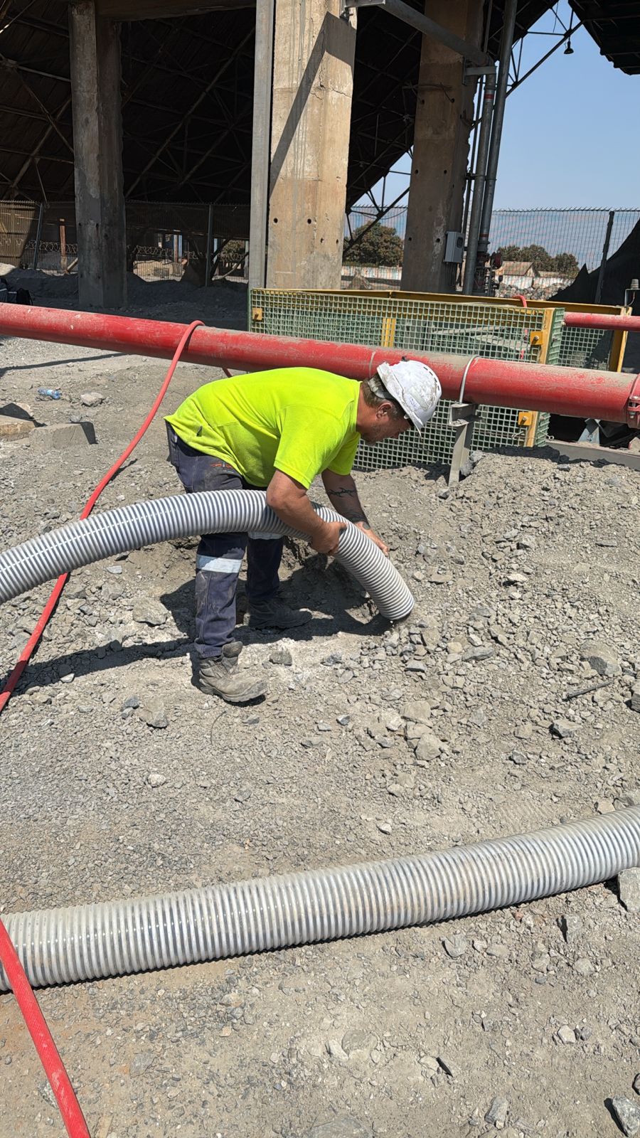Construction worker installing flexible ducting system